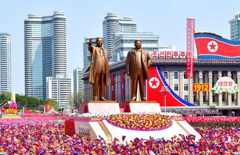 Der Demonstrationszug mit Bronzestatuen von Kim Il Sung und Kim Jong Il tritt auf den Platz des Fests ein.